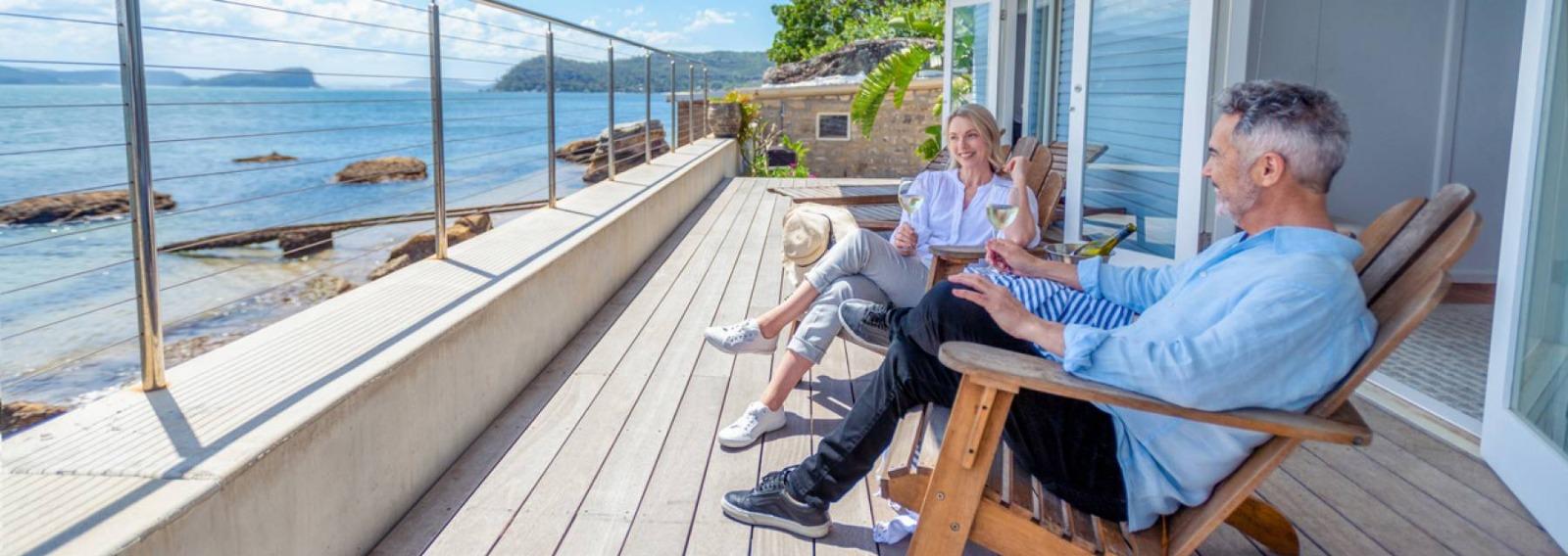 Couple having drinks on beachfront patio